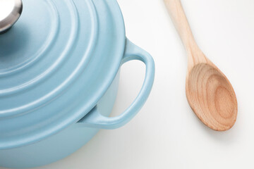Light blue pot and a wooden spoon