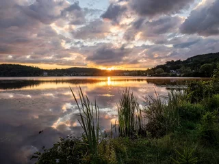 Foto op Canvas During the summer a sunrise appears across Head Lake in Haliburton, Ontario, Canada © Jonathan Dakin