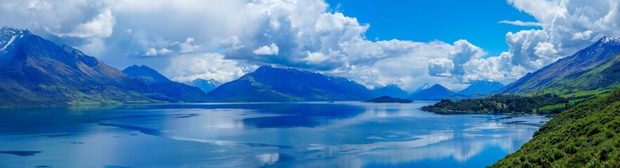 Naklejka na ściany i meble Panoramic view of beautiful reflections in alpine lake