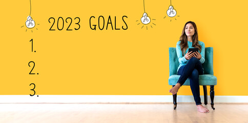 2023 goals with young woman holding a tablet computer