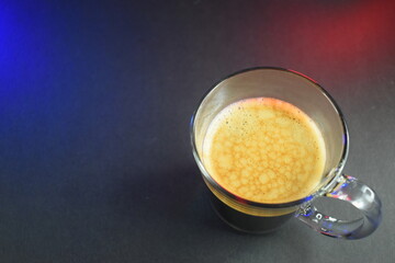 black coffe on black table with neon lights