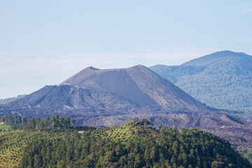 The landscape of Paricutin Volcano in Michoacan, Mexico. View of the mountains, a volcano ans the sky. 
