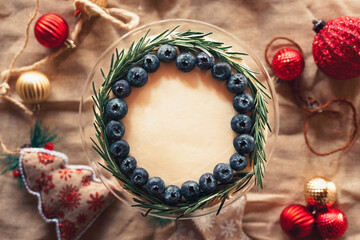 Top view of a blackberry and rosemary pie with Christmas decorations.