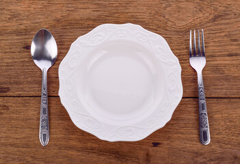 plate and spoon fork on wooden floor