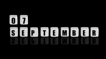 Fototapeta premium September 7th. Day 7 of month, Calendar date. White cubes with text on black background with reflection. Autumn month, day of year concept