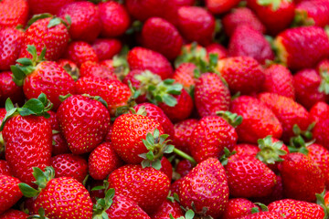 Red strawberries in market. Fresh fruit on stall. Harvest, food background concepts