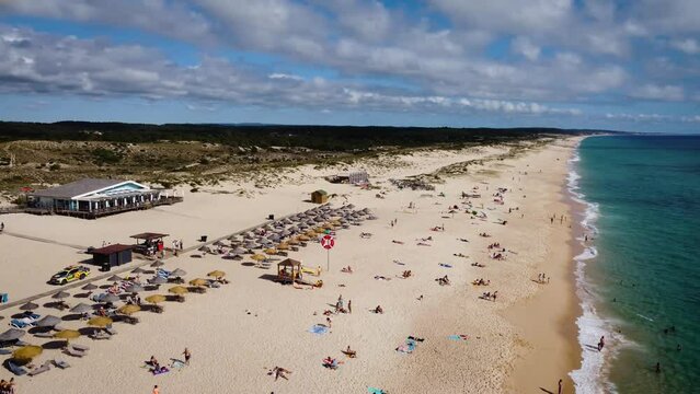 Comporta Beach and Comporta Café on the Portugal coast on a Blue sky with clouds and blue ocean