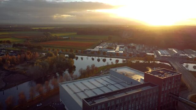 Helmond city along farm filed full of tulips with Sunset in the background. Helmondse Badminton Bond