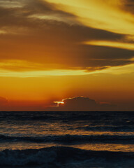 Naklejka na ściany i meble View of the golden sunset near the sea.