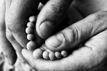 Mother is doing massage on her baby foot. Prevention of flat feet, development, muscle tone, dysplasia. 