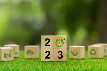 Goal in the new year 2023.2023 written on wooden cubes with environment icon .green community.new green business. plan, green community. Goals, opportunity, environmental sustainability target.
