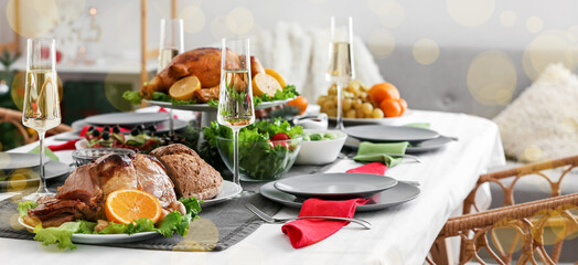 Christmas table setting with tasty dishes and champagne in dining room
