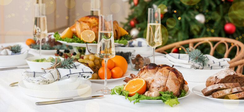Christmas table setting with tasty dishes and champagne at home