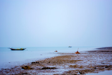 Fototapeta premium Wooden country made fishing boat floating on blue sea