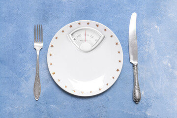 Plate and cutlery on light blue background. Diet concept
