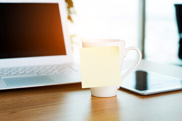 Empty adhesive paper on cup in office