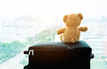 Teddy bear waiting on a suitcase