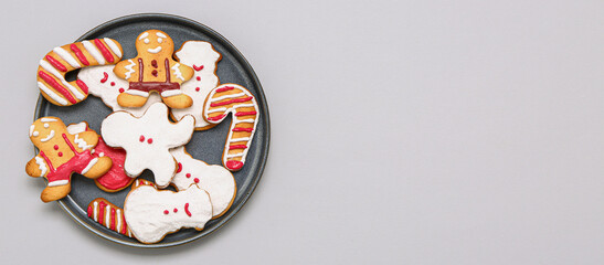 Plate of different Christmas cookies on grey background with space for text