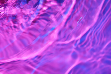 Texture of clean water on color background