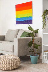 Interior of light living room with sofa and rainbow painting