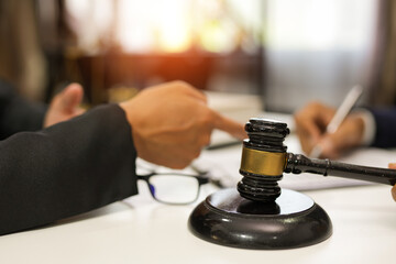 judge on wooden table And experienced lawyers meet with clients and give advice behind the scenes. legal services legal consulting concept