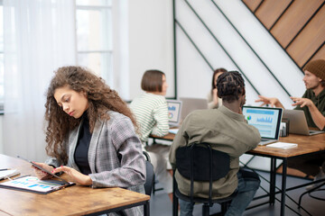 young business woman with a digital tablet working in a coworking center.