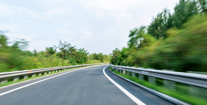 Empty curved road in motion blur