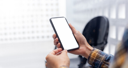 cell phone blank white screen mockup.hand holding texting using mobile on desk at office.background empty space for advertise.work people contact marketing business,technology