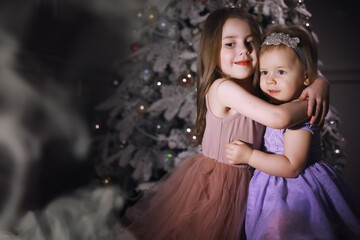 Child in smart clothes in front of the Christmas tree. New Years Eve. Waiting for the new year.