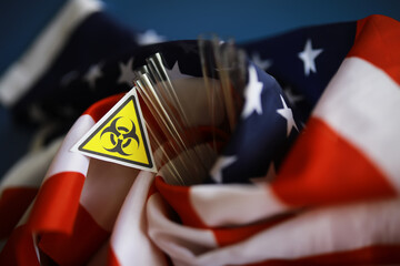 American flag and biohazard sign. The concept of American biolabs and research centers.