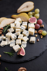Sliced Traditional Italian Gorgonzola cheese on stone seving board