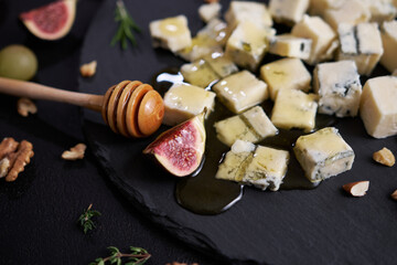 Sliced Traditional Italian Gorgonzola cheese on stone seving board