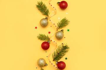 Composition with Christmas balls and fir branches on color background
