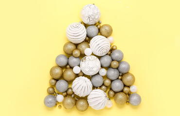 Christmas tree made of different balls on color background