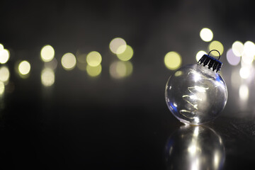 Christmas toy. Large glass golden ball on new year tree background. Interior decor for New Year's Eve