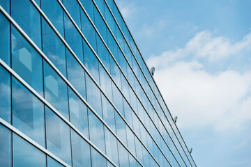 Fototapeta na wymiar Part of modern business building against blue sky