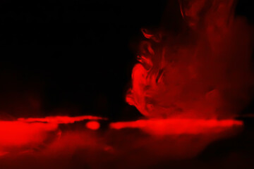Red smoke over black studio background. Red steam on a black background. Copy space.