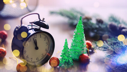 Fototapeta na wymiar Christmas gifts, fir branches and alarm clock on wooden table. Boxing day