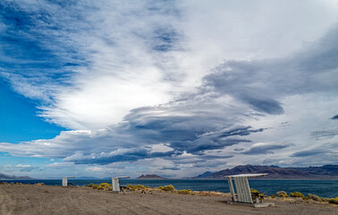 Sheltered picnic tables line the shore of Pyramid Lake at Karaban Beach in Nevada, USA