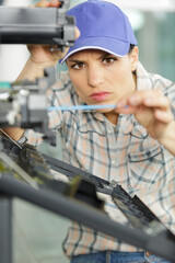 Obraz na płótnie Canvas female technician working on photocopier
