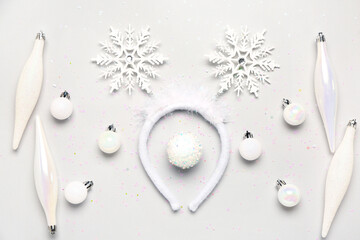 Composition with beautiful Christmas headband and decorations on light background