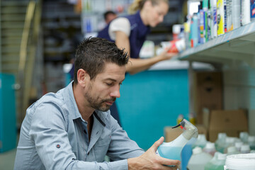 client reading the label of a spray product