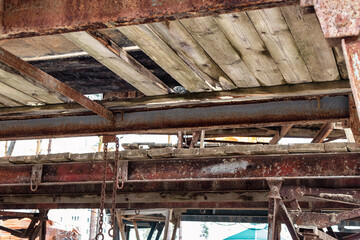 Reinforced scaffolding for the work of masons in the construction of brick walls. Apparel for work on the construction site and storage of materials. Close-up. Construction of brick walls.