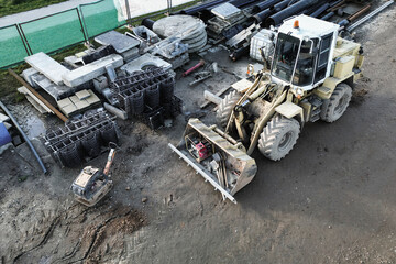 Fototapeta premium Powerful heavy loader or dozer. view from above. drone photography. Earthworks with heavy equipment at the construction site. road construction equipment.