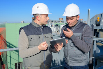 discussing a construction project on tablet