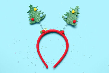 Funny Christmas headband and sequins on color background