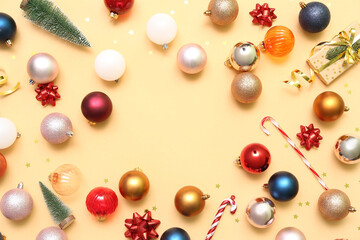 Frame made of different Christmas decorations on color background