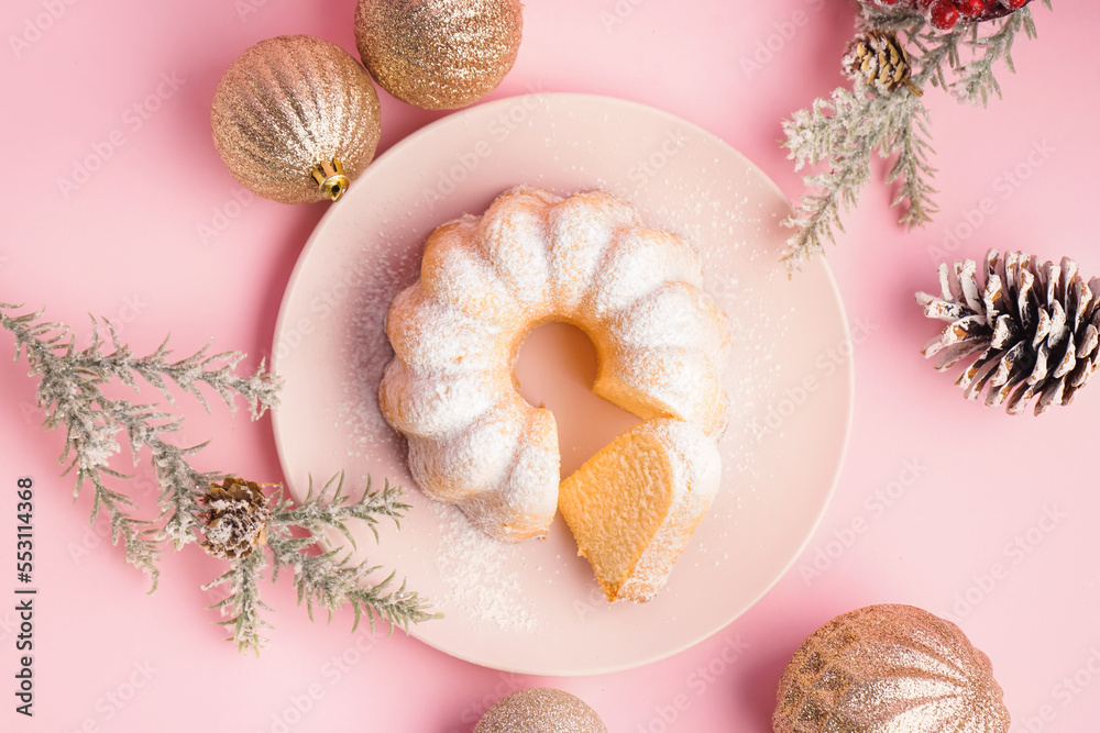 Wall mural plate with tasty christmas cake and decorations on pink background