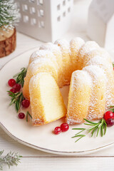 Plate with tasty Christmas cake on light wooden table, closeup