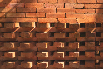The old vintage brick wall background are arranged in alternating pattern to create air vents and...